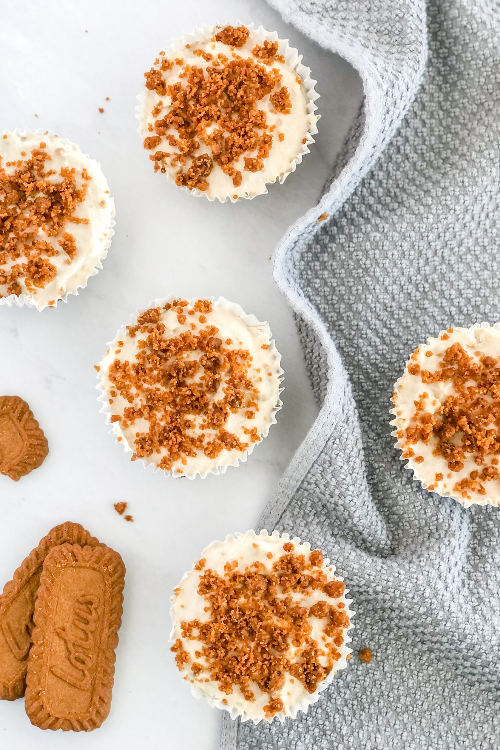 mini biscoff cheesecakes on a grey kitchen towel