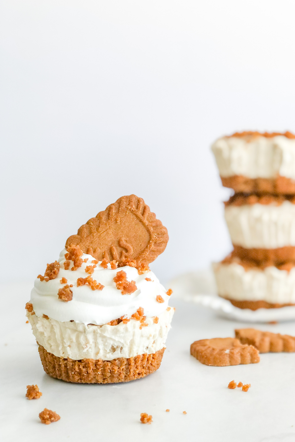 mini biscoff cheesecake with whipped cream on top and a lotus biscoff cookie