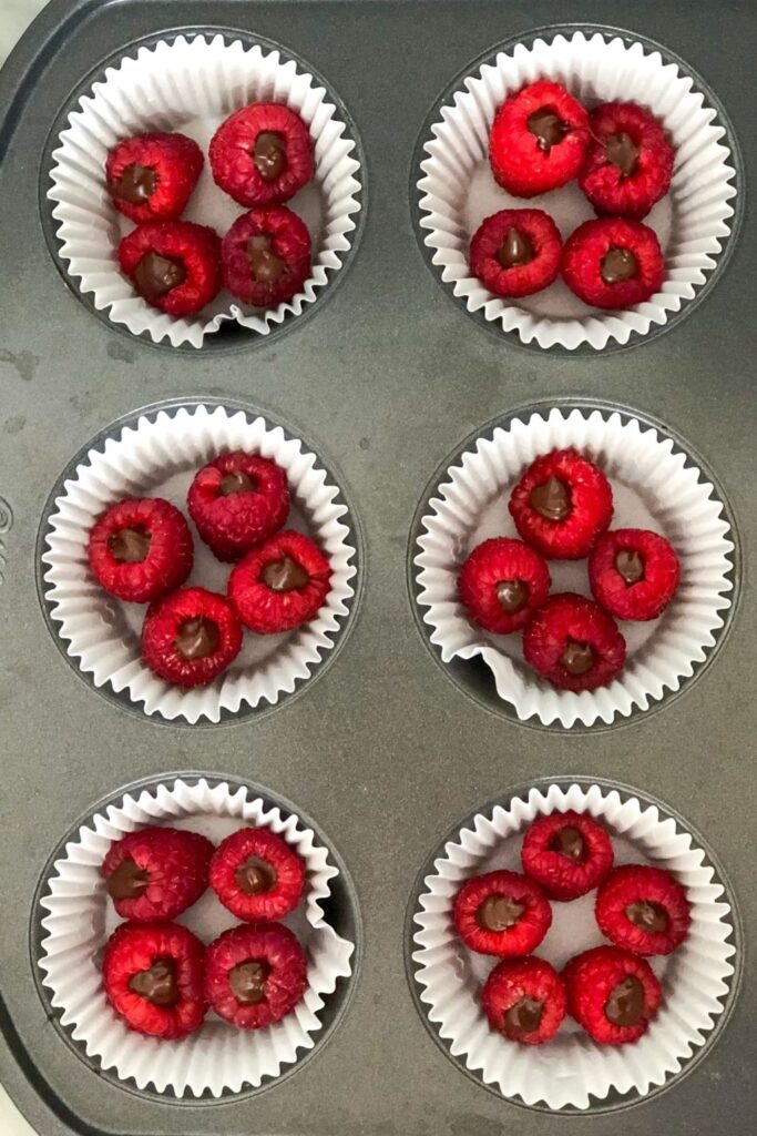 dark chocolate filled raspberries in a muffin tin