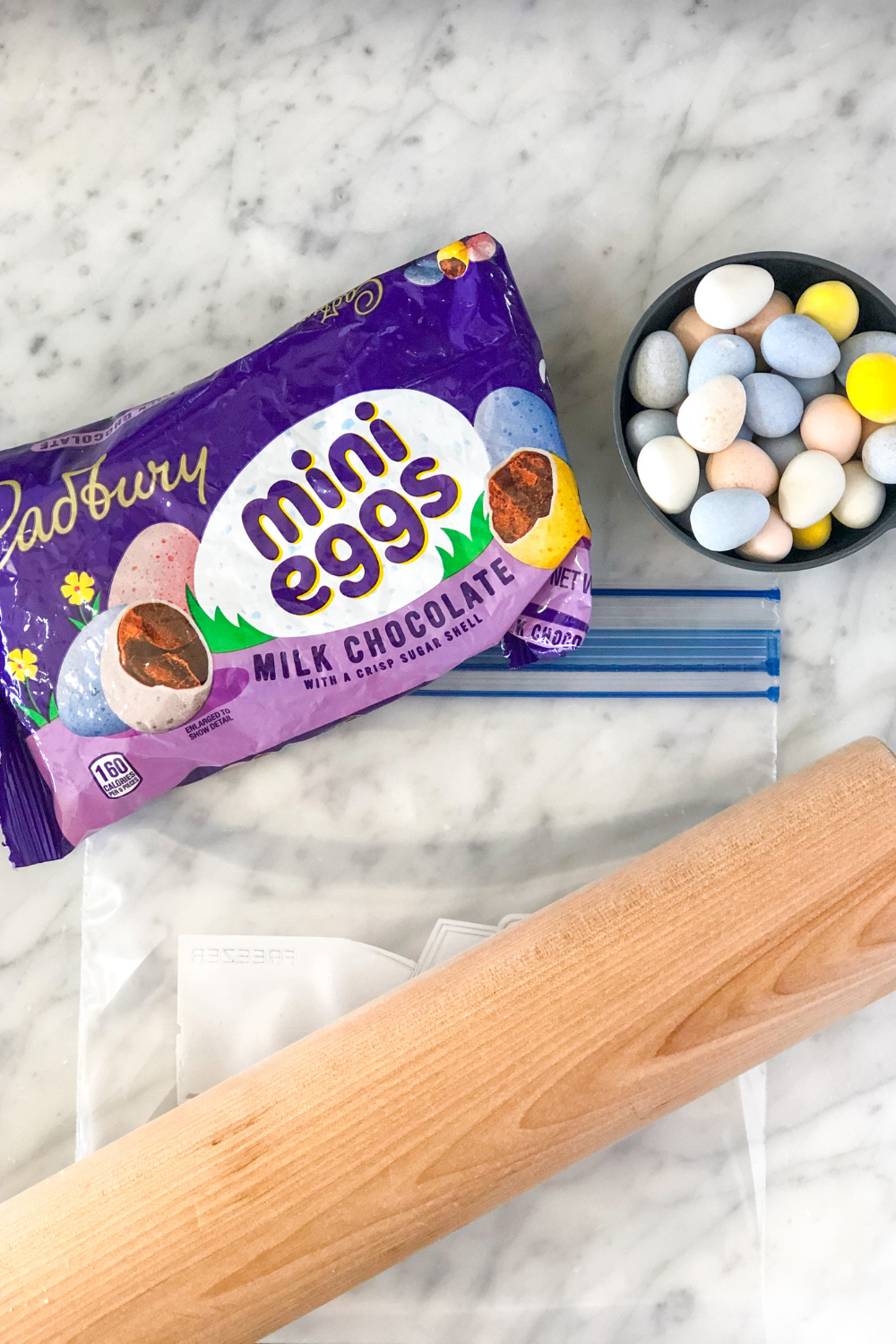 a bag of Cadbury mini eggs next to a rolling pin