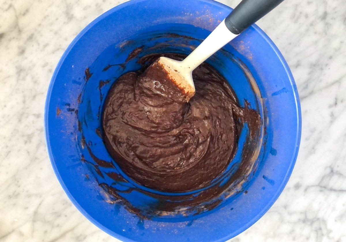 brownie batter in a blue mixing bowl