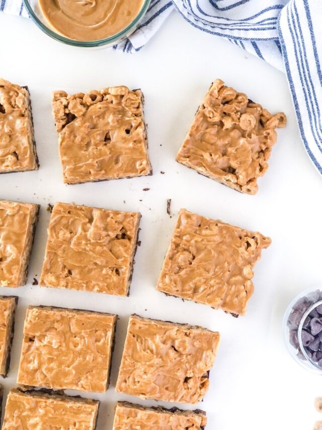 sliced peanut butter chocolate cheerio bars with a bowl of peanut butter