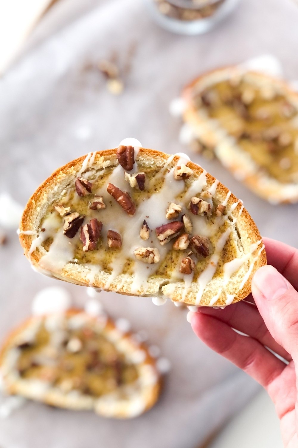 slice of toasted french bread with chai spiced custard, chopped pecans, and icing