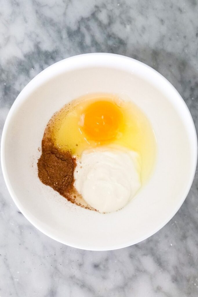 egg, yogurt, and homemade chai spice in a bowl