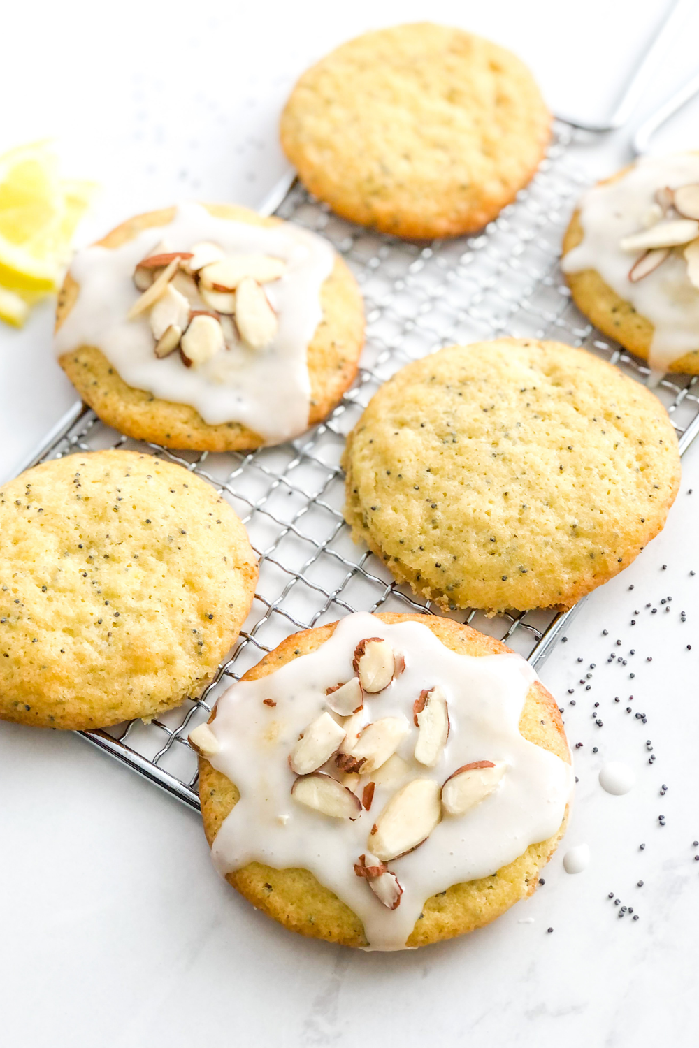 mascarpone lemon poppy seed cookies with icing and sliced almonds
