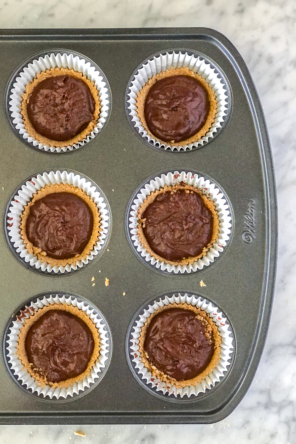 chocolate nutella mini tarts in a muffin pan