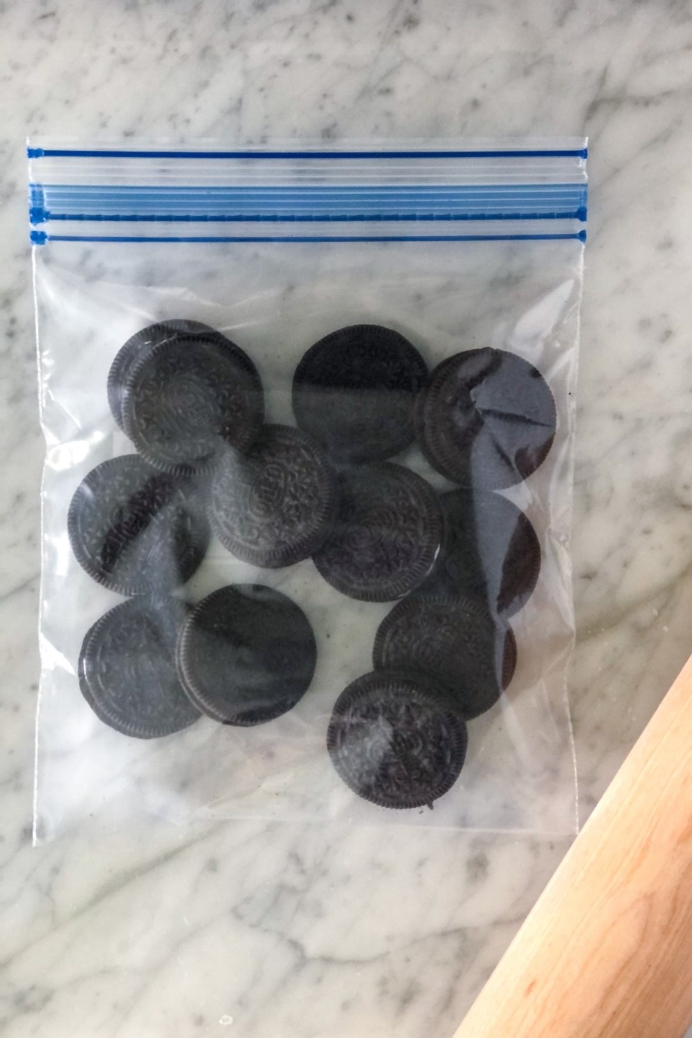 Oreos in a zippable plastic bag with a rolling pin