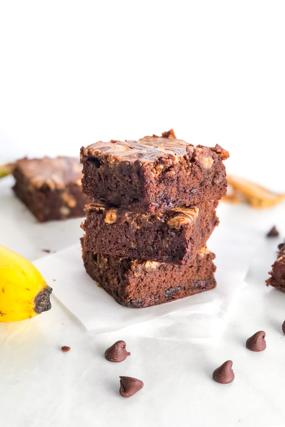 stack of brownies with banana, peanut butter, and chocolate chips