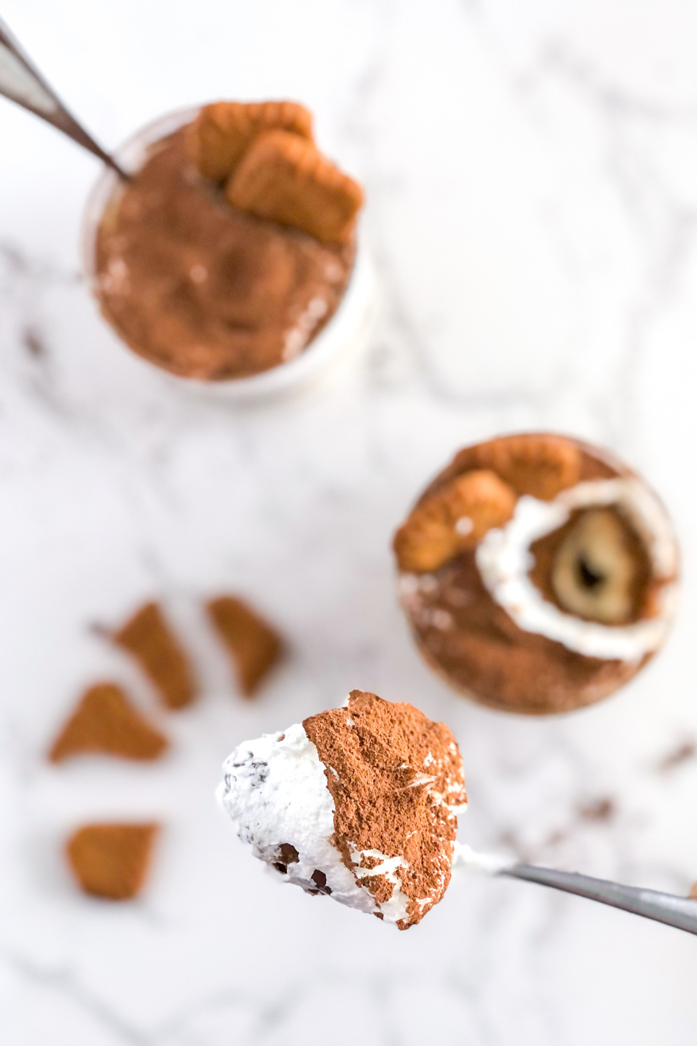 a spoonful of Biscoff tiramisu with cocoa powder