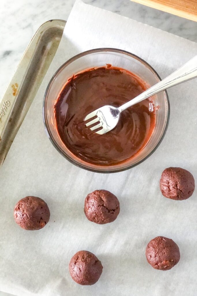 chocolate truffles rolled into balls on parchment paper