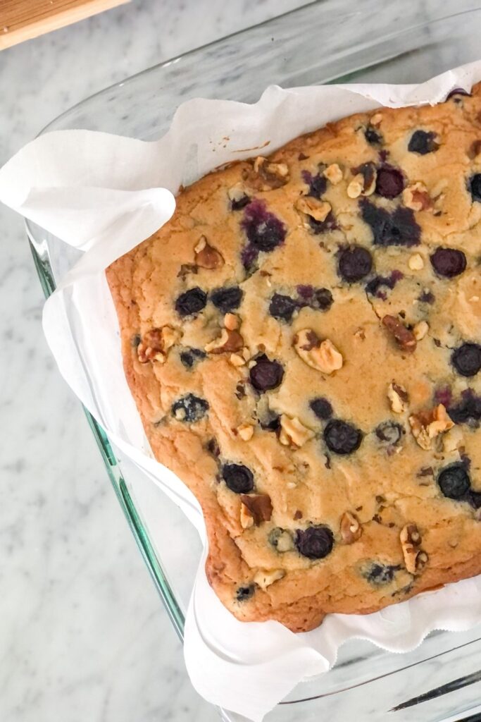 baked blueberry walnut bars in a square glass baking pan