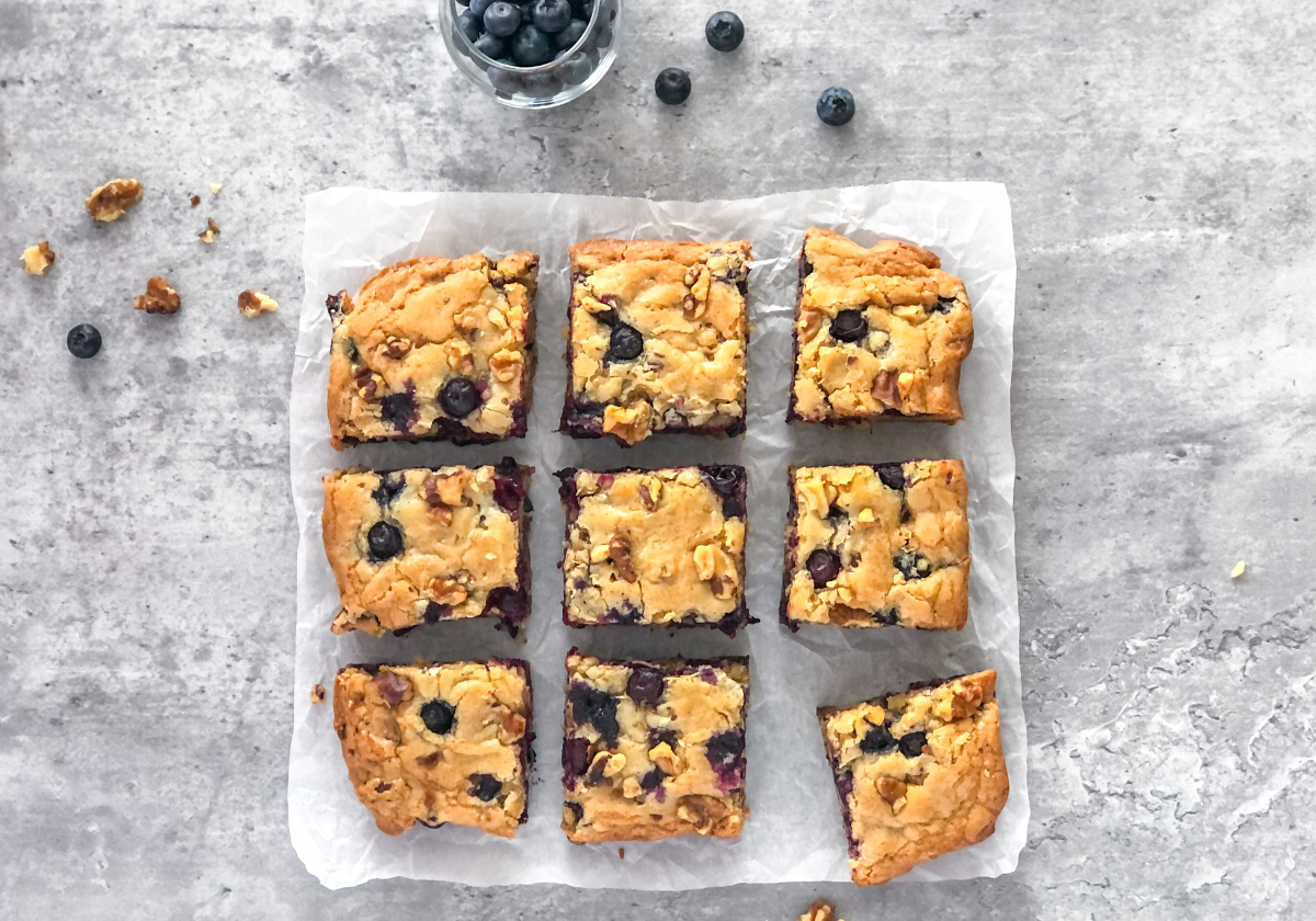 blueberry walnut blondie bars on parchment paper