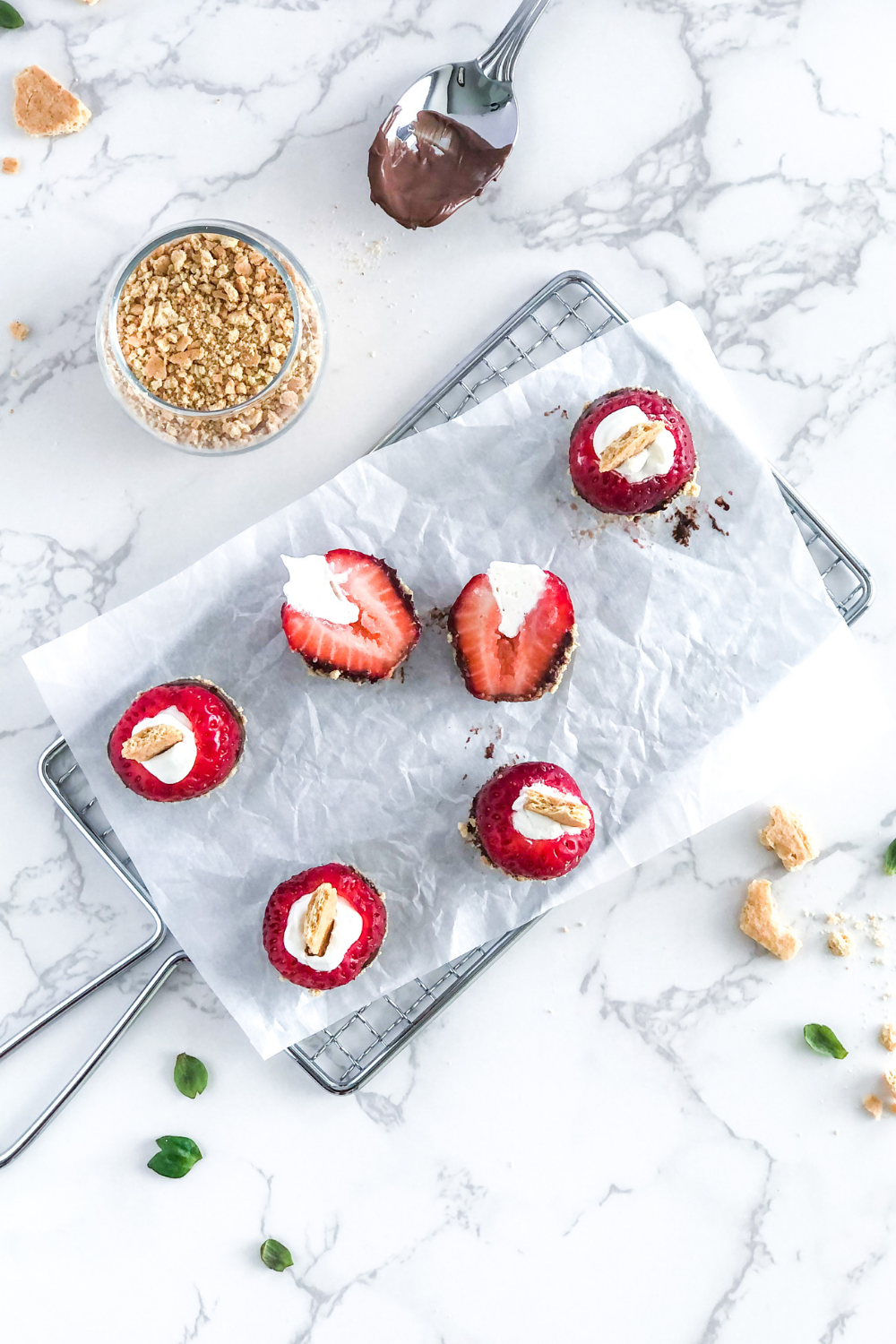 chocolate and Nutella strawberry bites on parchment paper