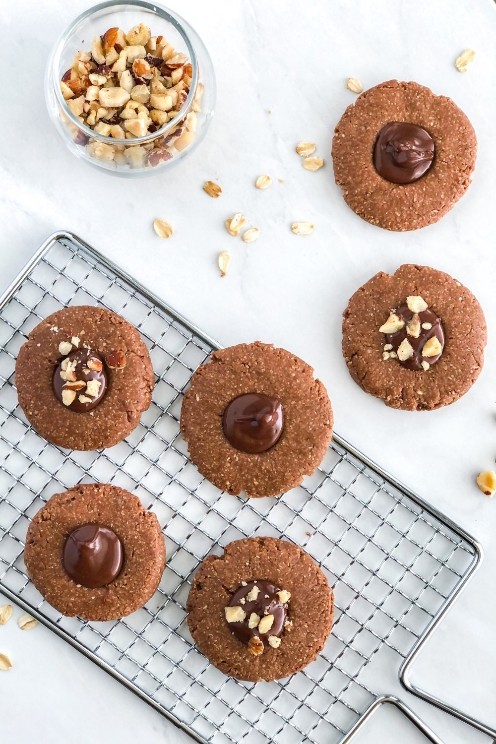 no bake chocolate hazelnut thumbprint cookies on a wire cooling rack