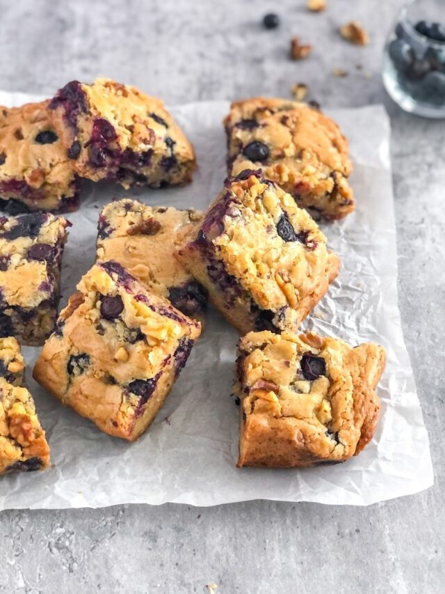 blueberry walnut blondies on parchment paper