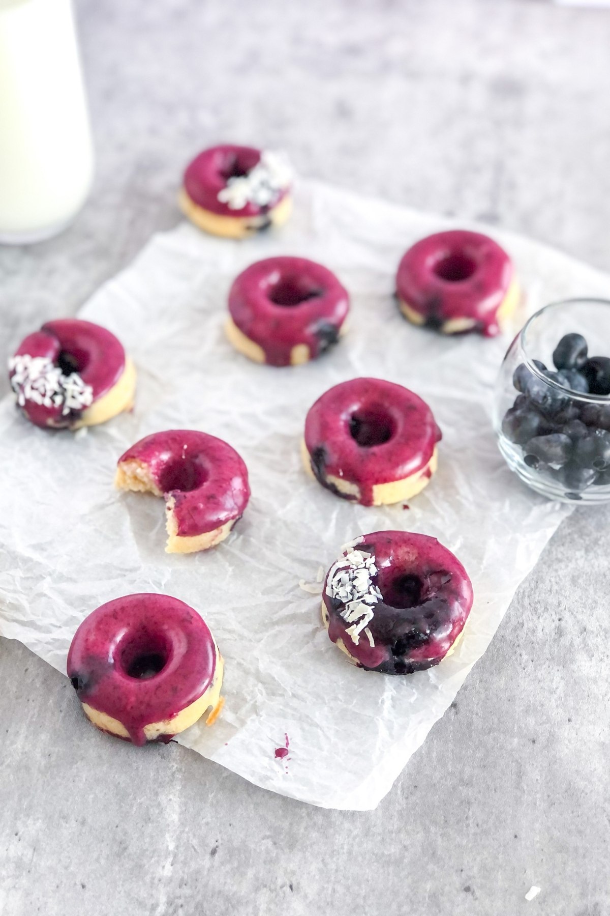 mini blueberry glazed donuts on parchment paper