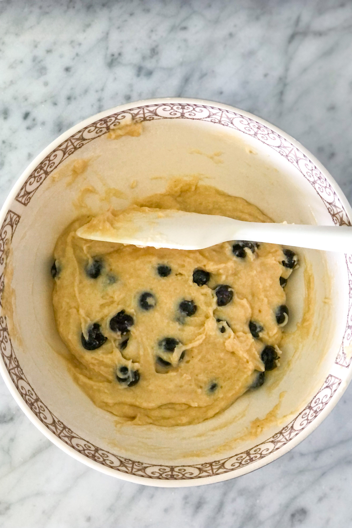 donut batter in a large bowl with a spatula