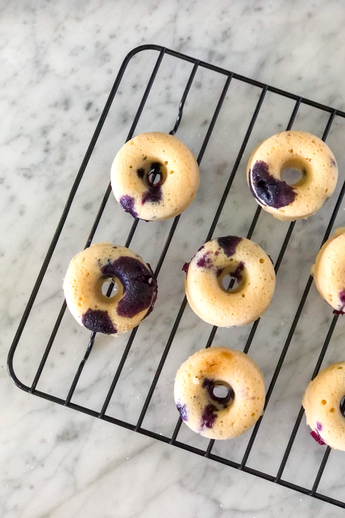 mini blueberry baked donuts on a cooling rack