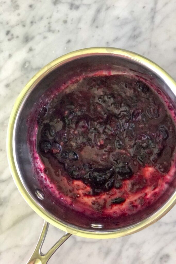 mashed blueberry sauce in a saucepan
