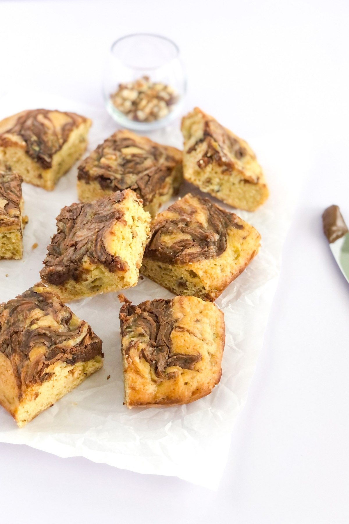 hazelnut banana bread bars with Nutella swirl on parchment paper
