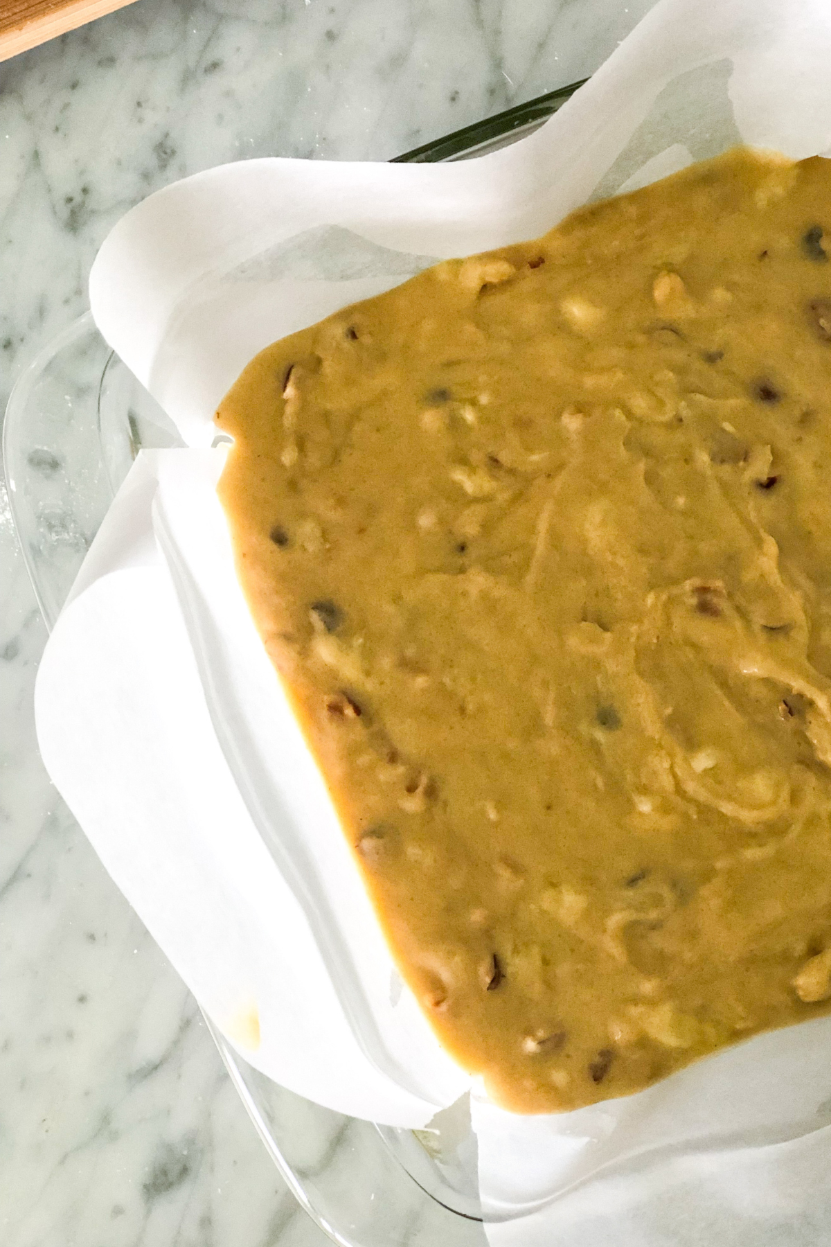 banana bread batter in a glass baking dish