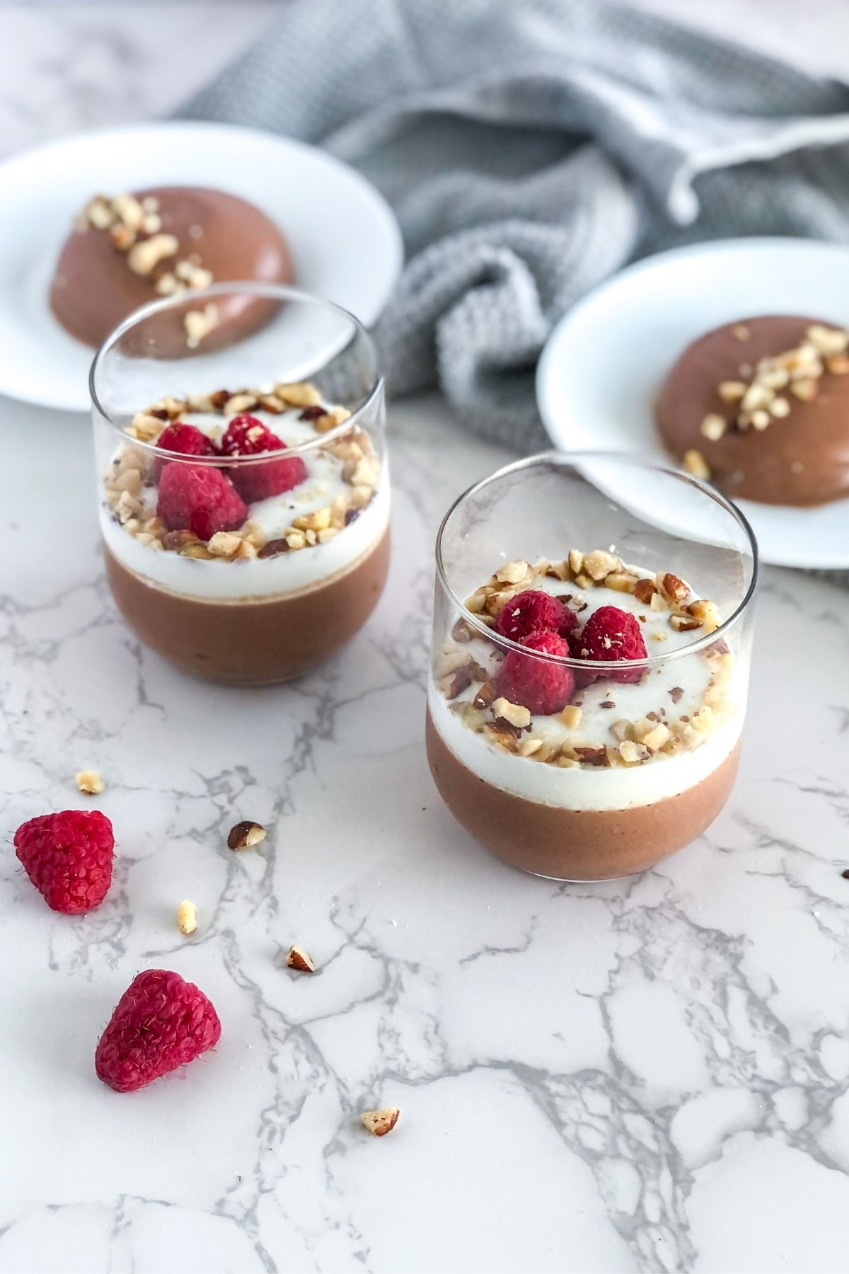 chocolate Nutella panna cotta in glasses with raspberries and hazelnuts