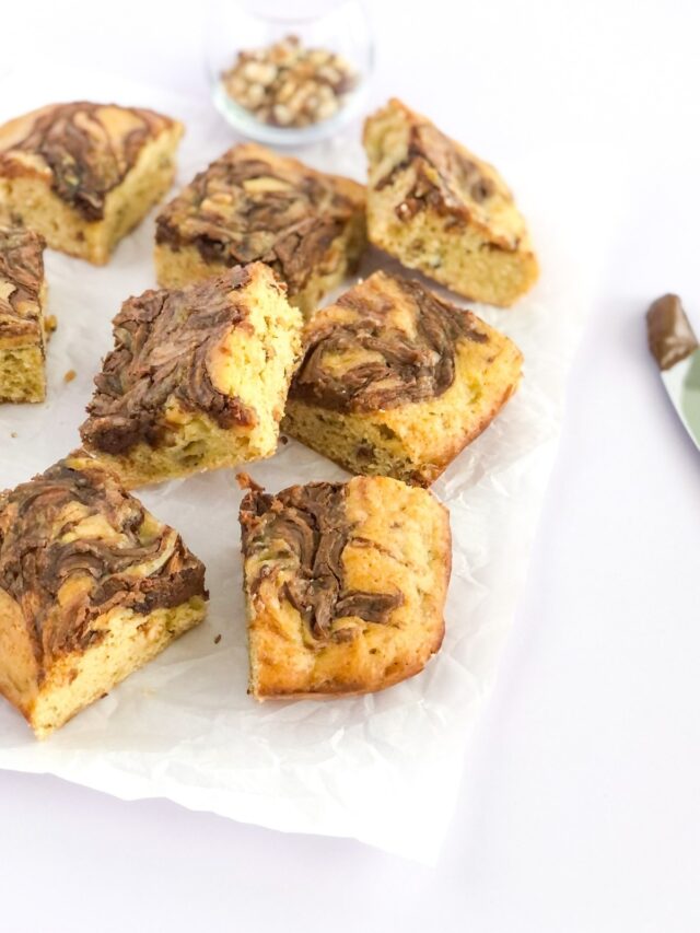 hazelnut banana bread bars with Nutella swirl on parchment paper
