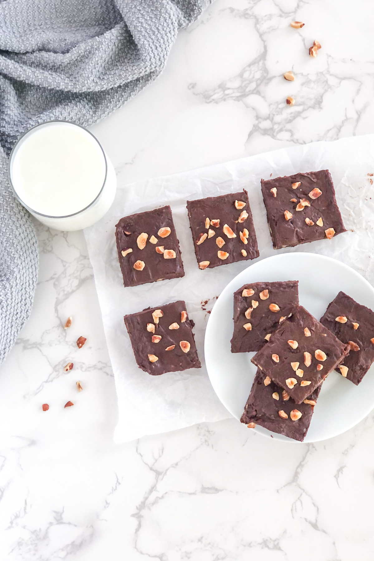 hazelnut fudge on a white plate with a glass of milk