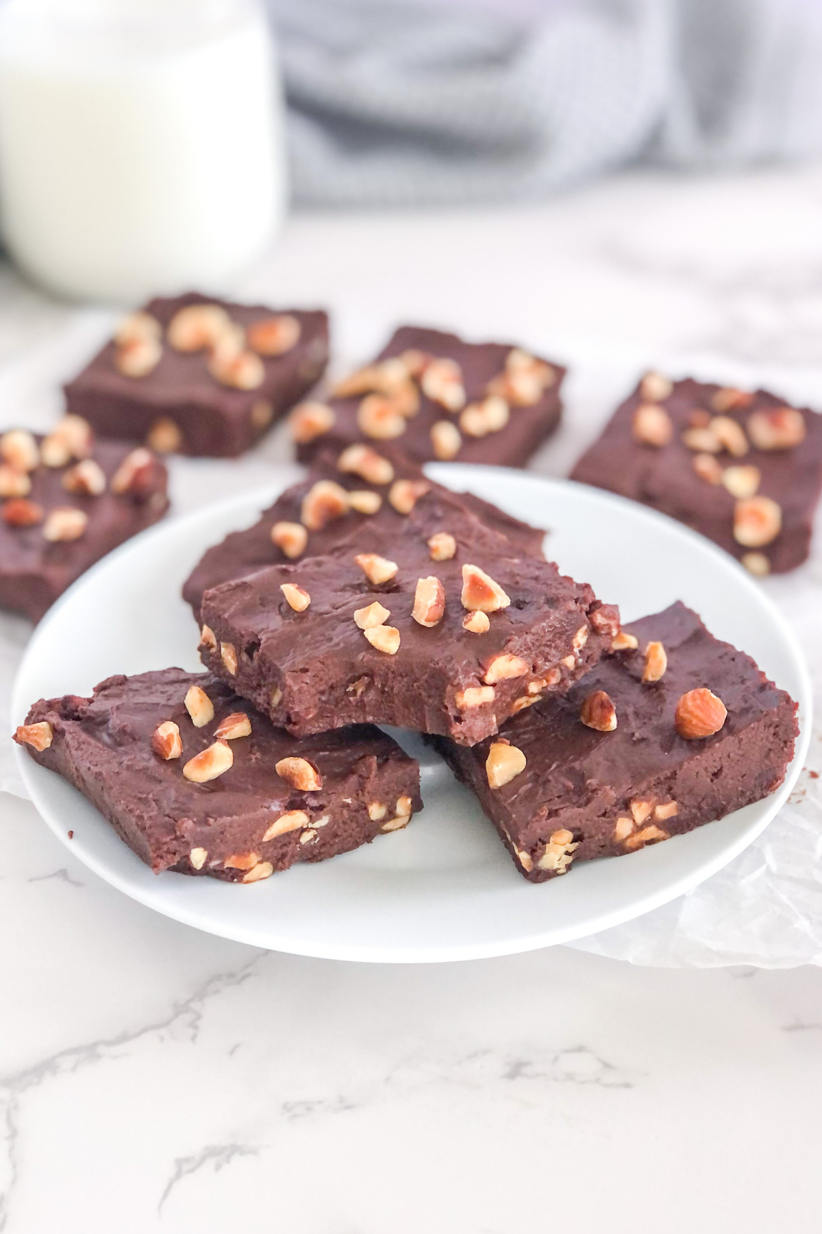 chocolate Nutella fudge with hazelnuts on a white plate