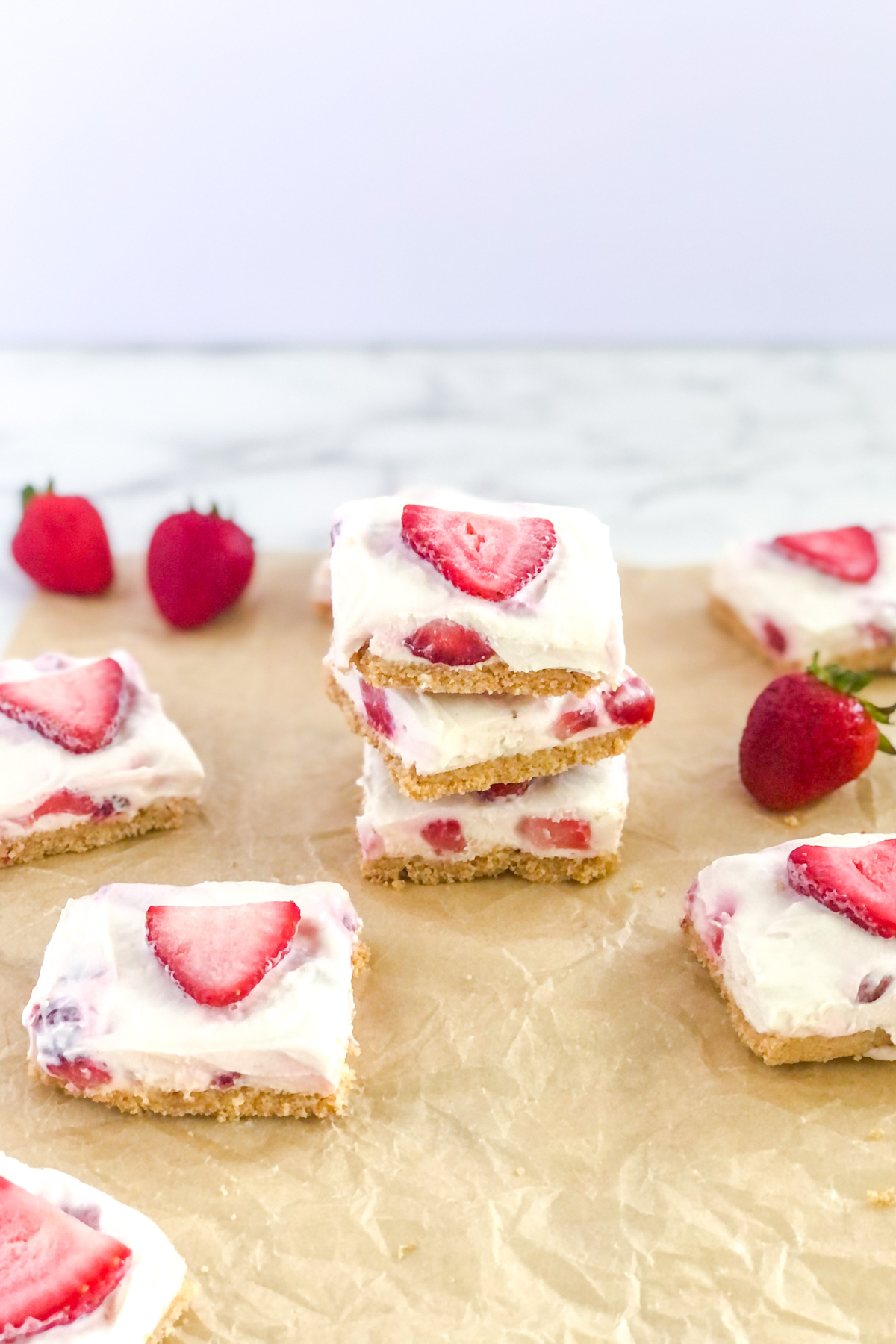 stack of strawberry cheesecake bars with graham cracker bars