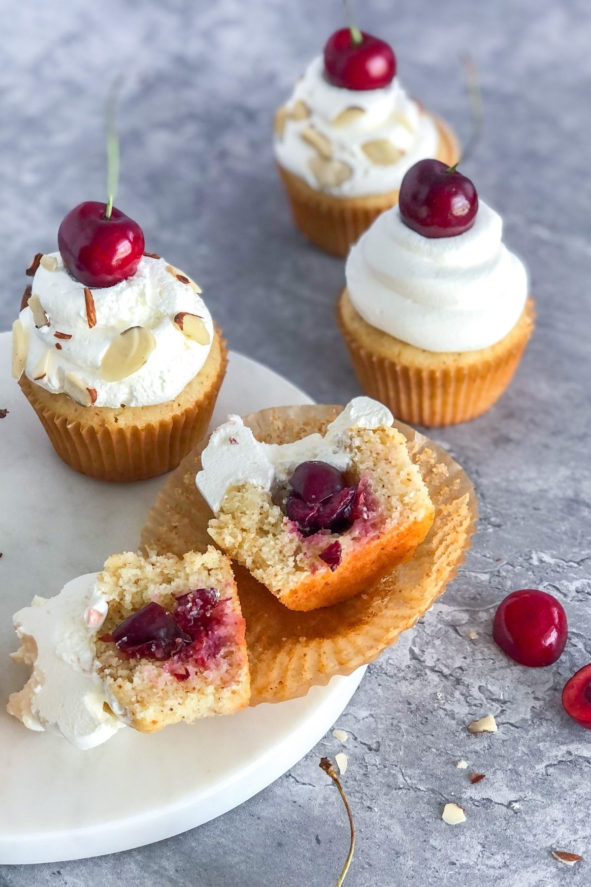 almond cupcakes with cherry filling cut in half