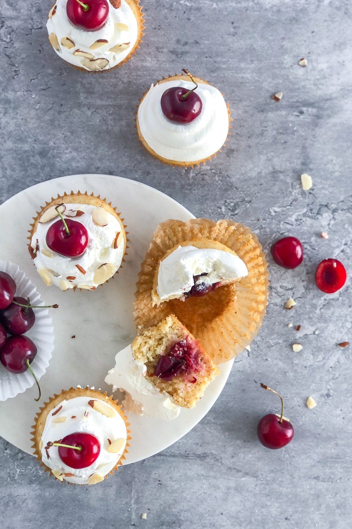 flat lay with cherry cupcakes sliced in half