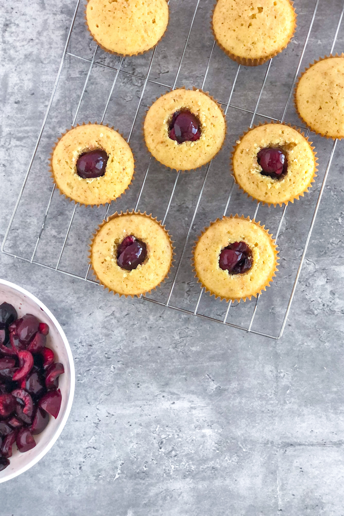 cherry filled cupcakes on a wire rack