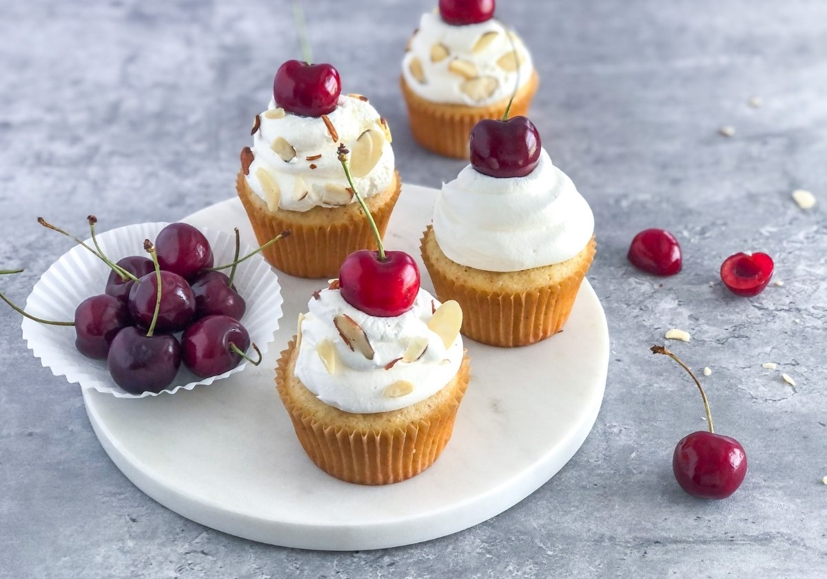 cherry almond cupcakes with whipped cream