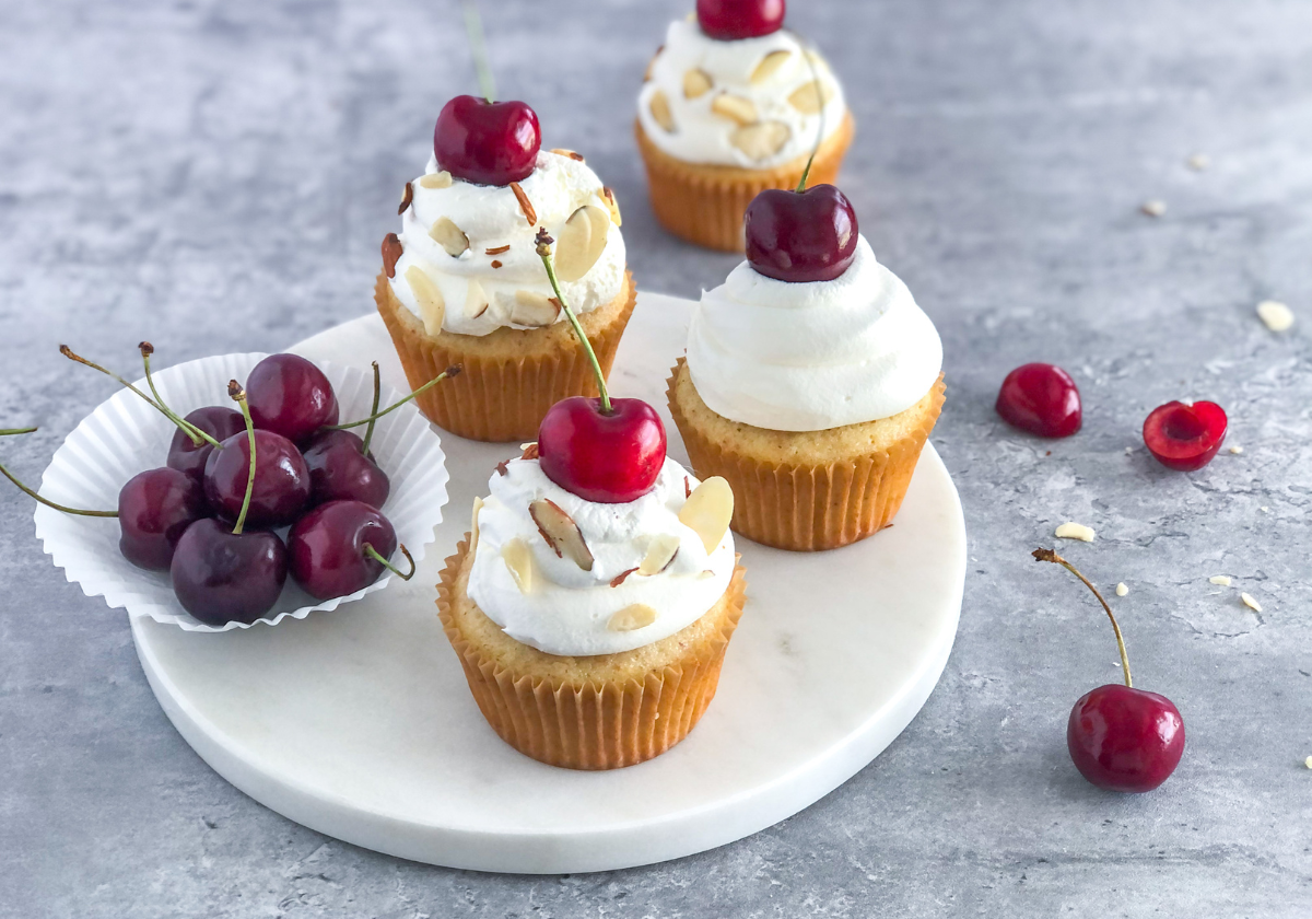 cherry almond cupcakes with whipped cream