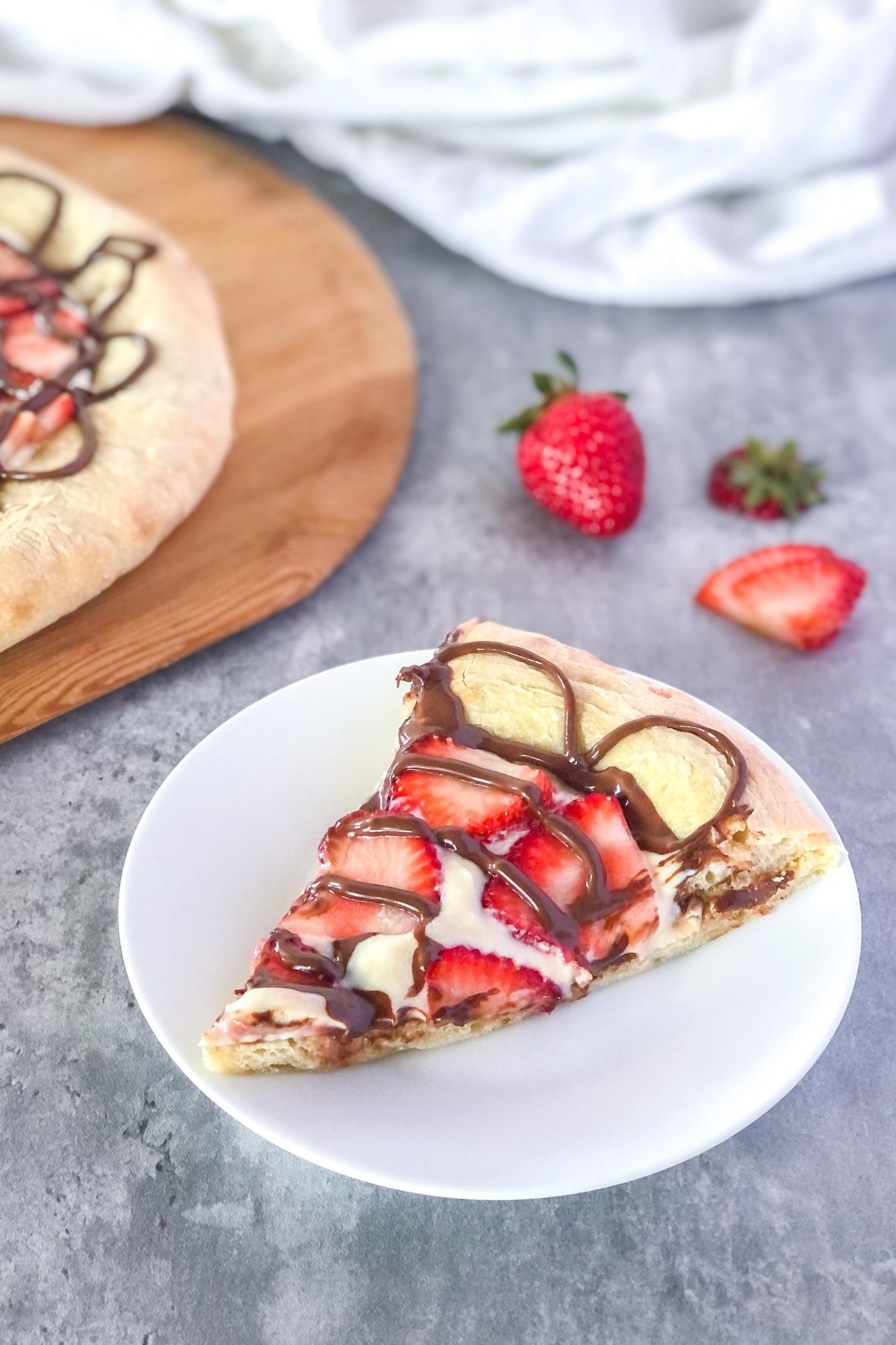 slice of Nutella dessert pizza with strawberries