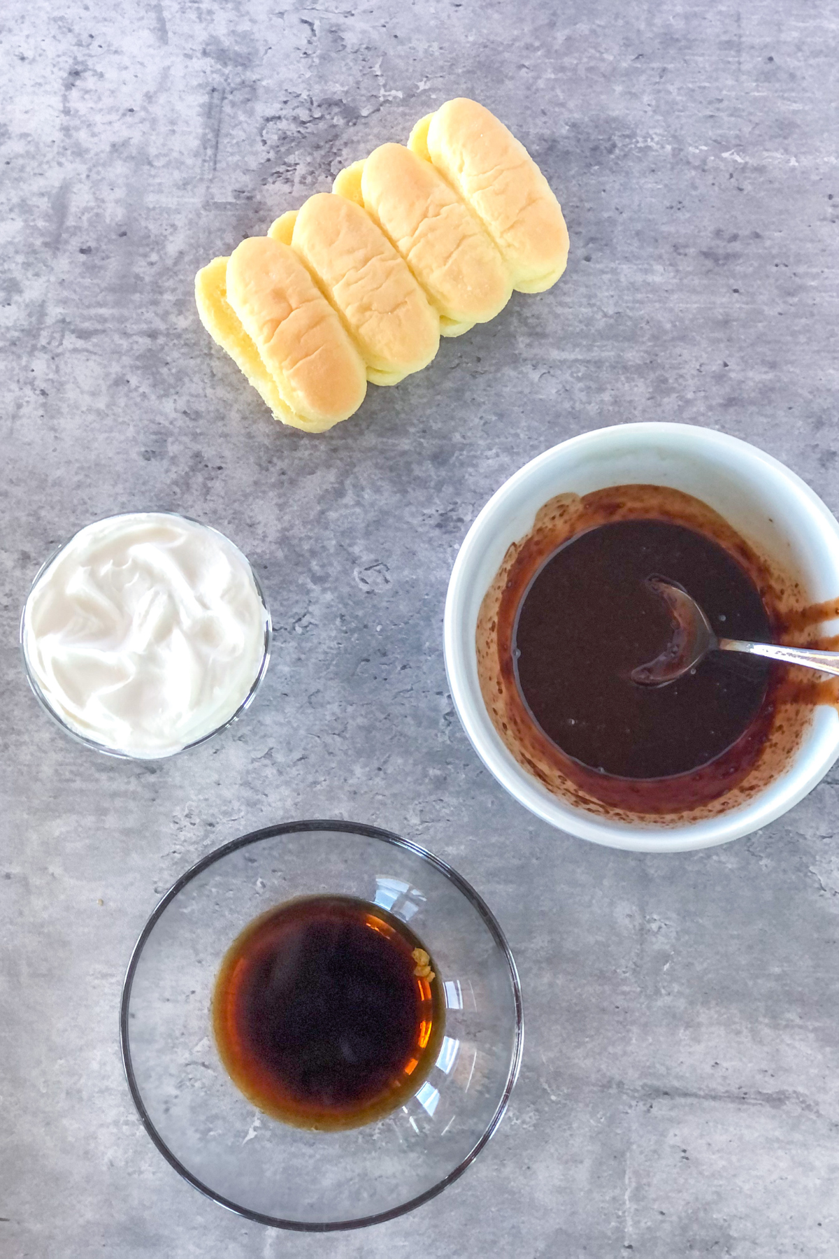 Nutella coffee mixture in a bowl next to a container of ladyfinger cookies
