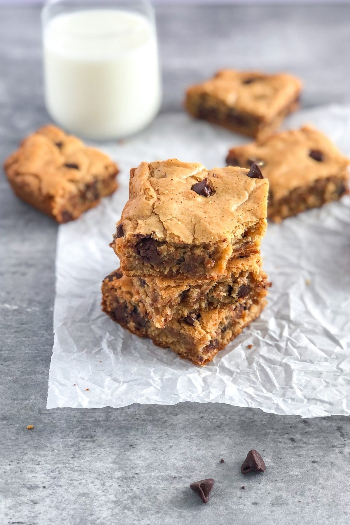 stack of chocolate chip almond butter cookie bars on parchment paper