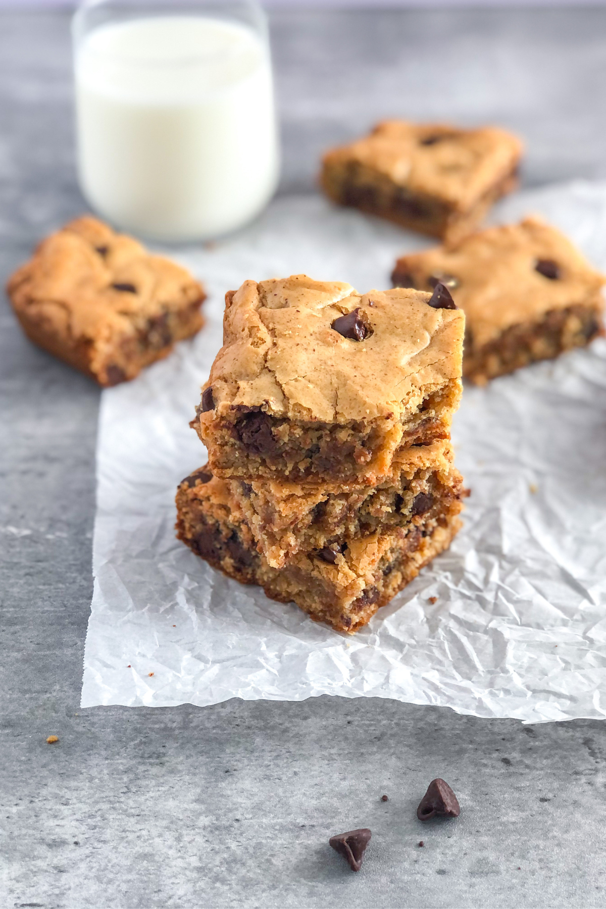 stack of chocolate chip almond butter cookie bars on parchment