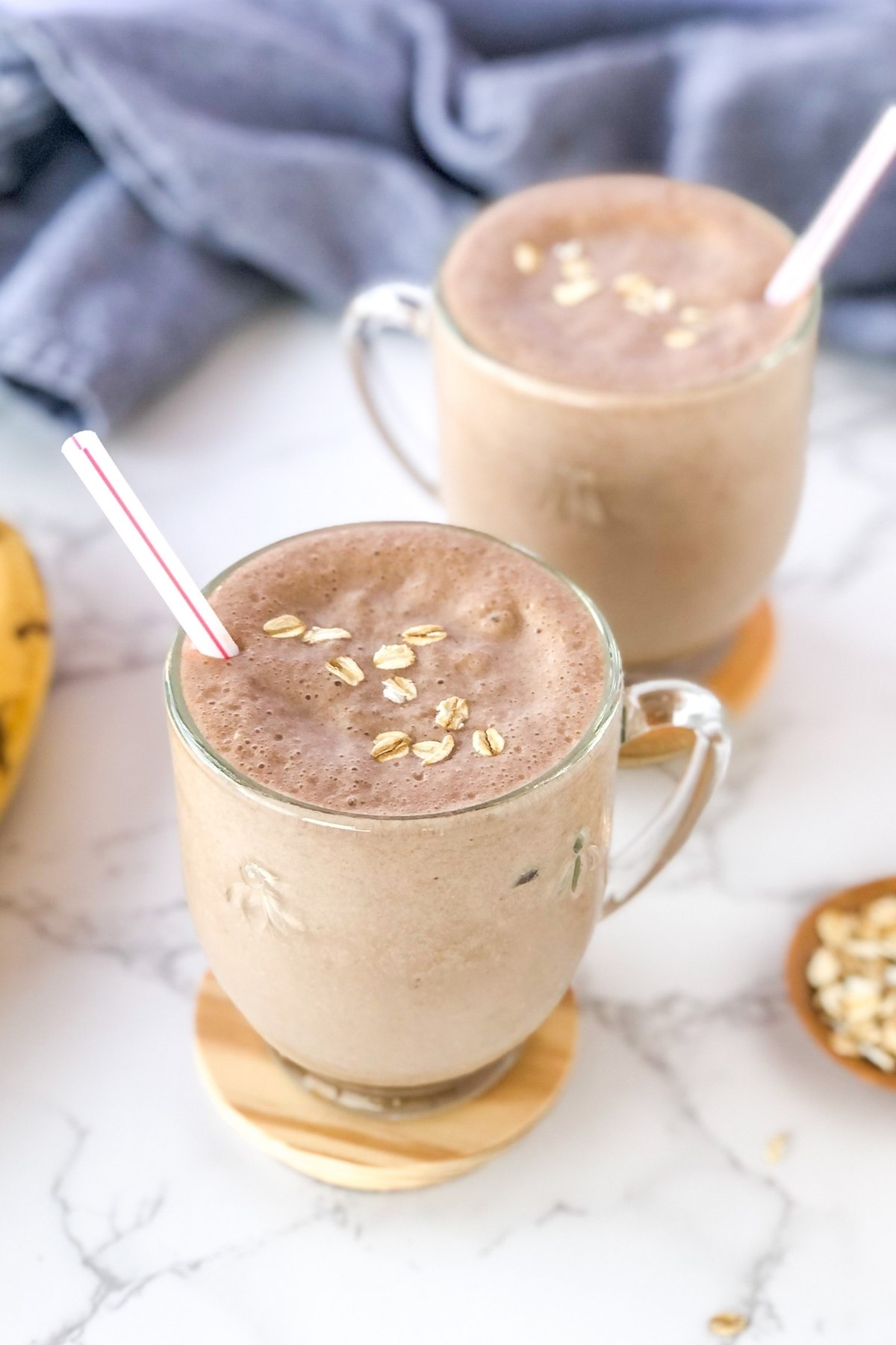 banana Nutella oatmeal smoothie with a blue kitchen towel