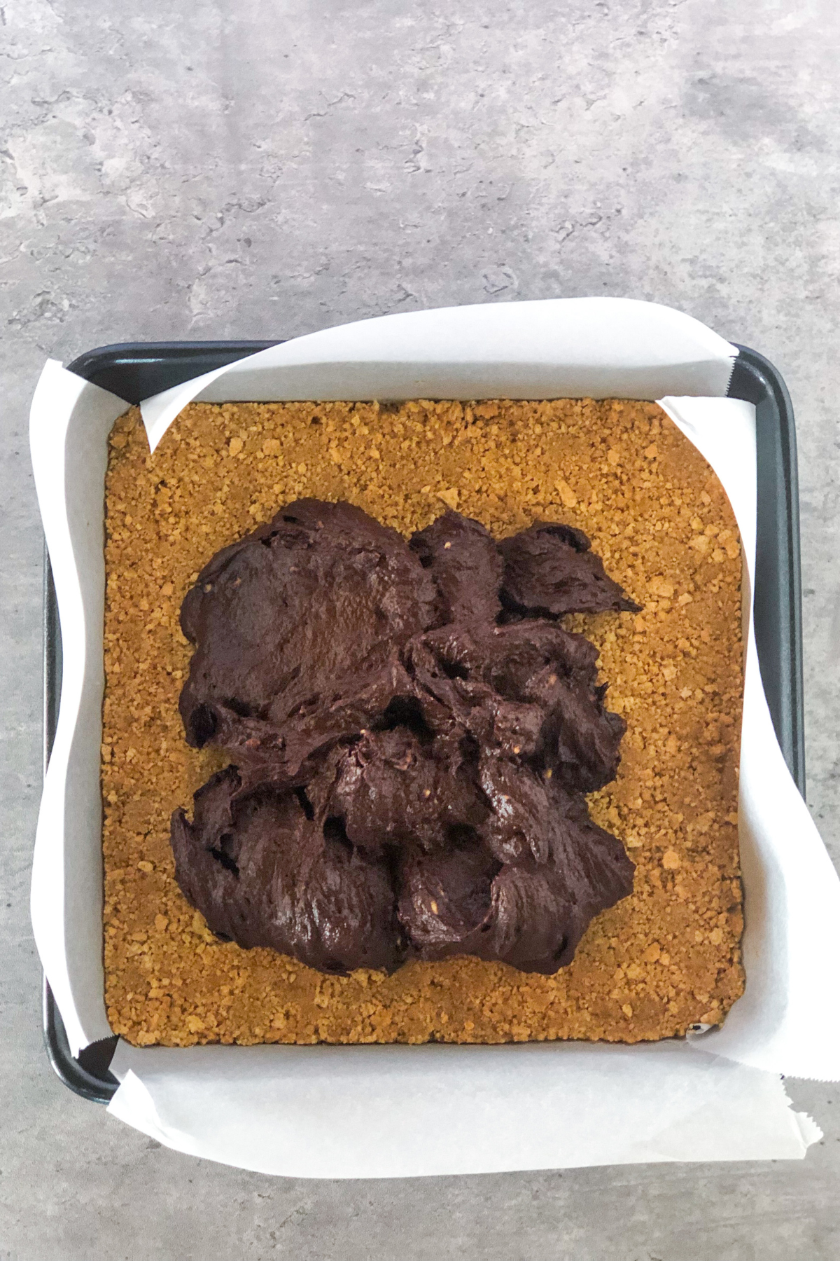 graham cracker crust with chocolate mixture spooned on top