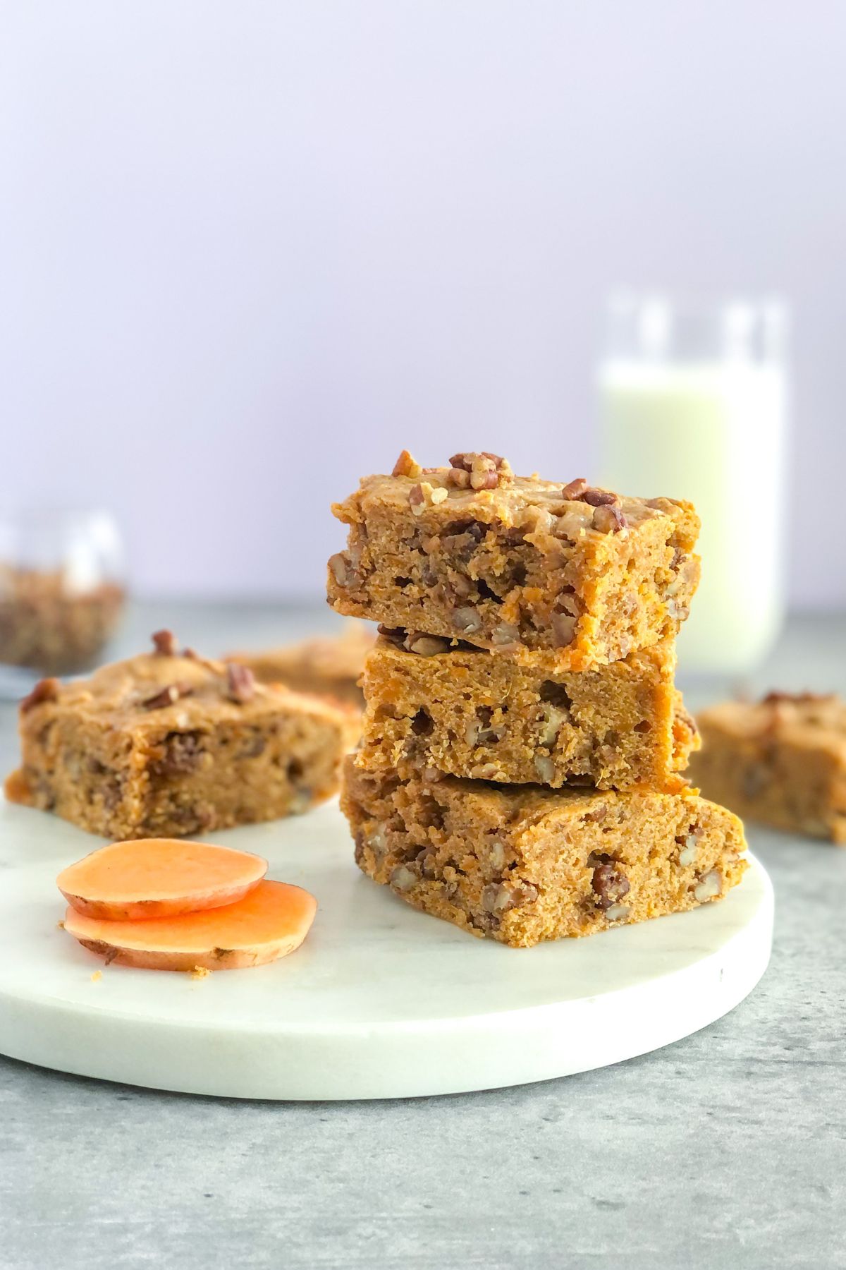 stack of sweet potato bars with pecans and a glass of milk