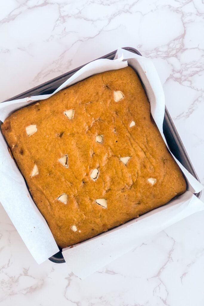 baked pumpkin bars with white chocolate in a baking pan