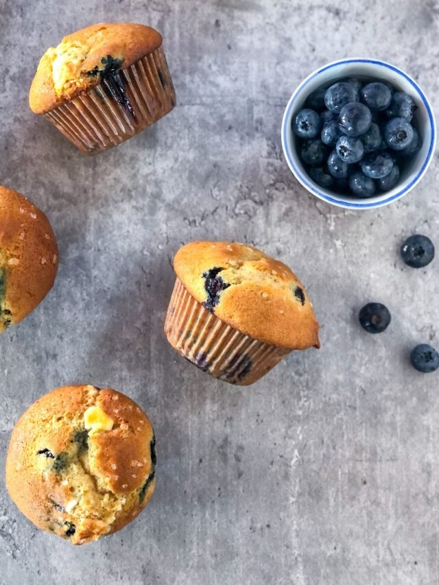 blueberry muffins with white chocolate on a grey surface