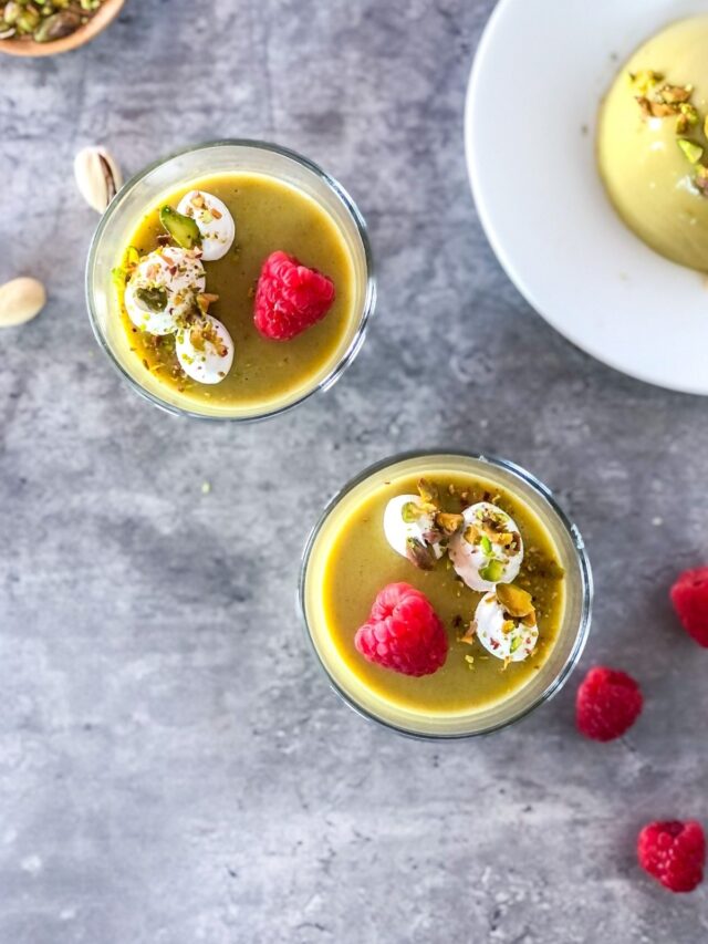 pistachio panna cotta with raspberries and whipped cream
