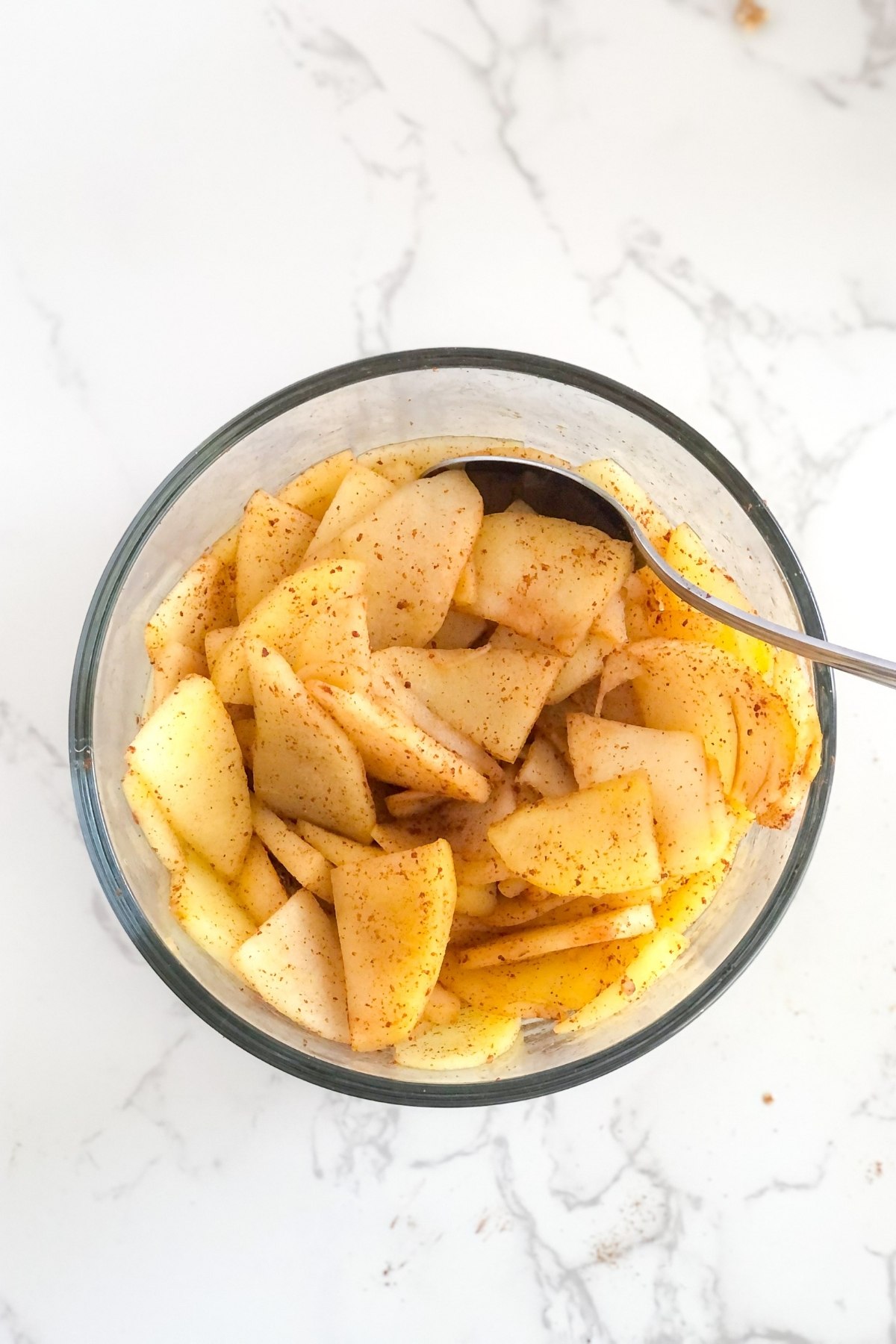 cooked cinnamon apples in a glass bowl
