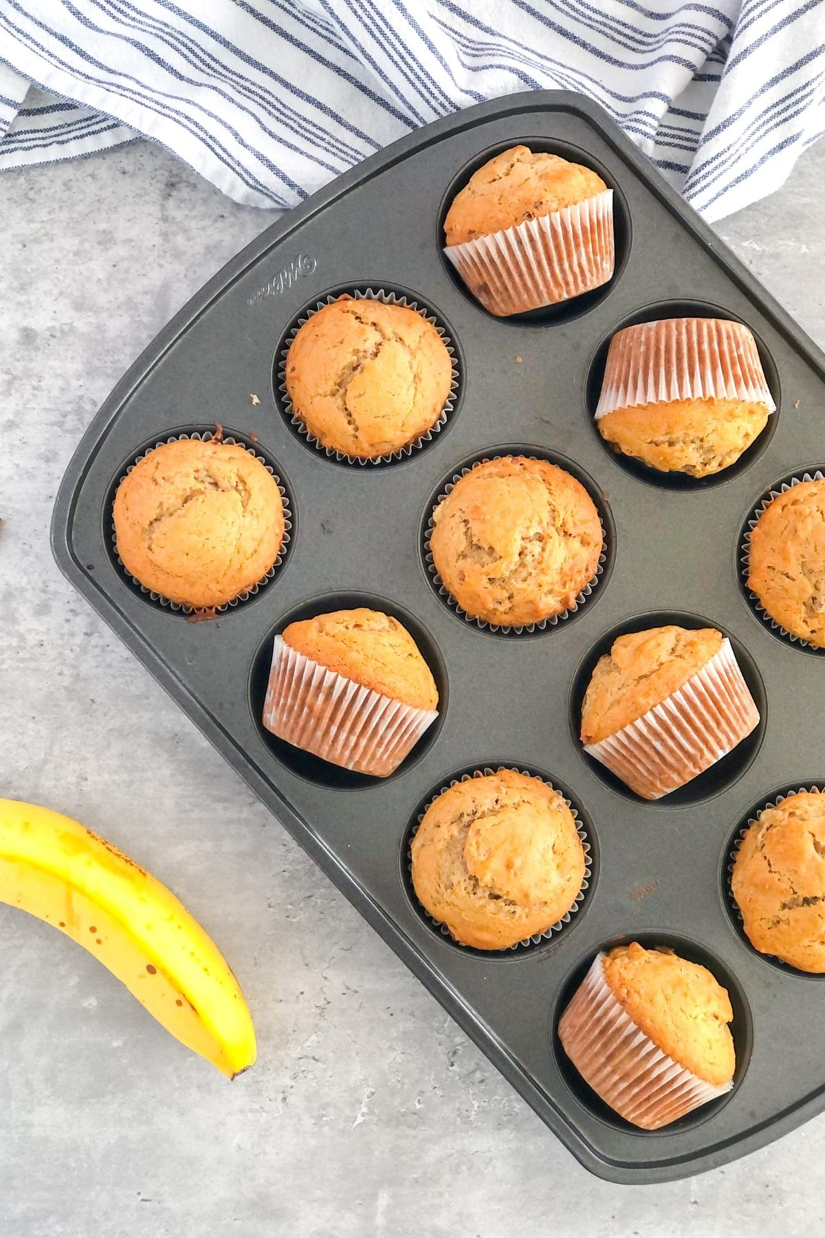 banana pecan muffins with biscoff spread in a muffin tin