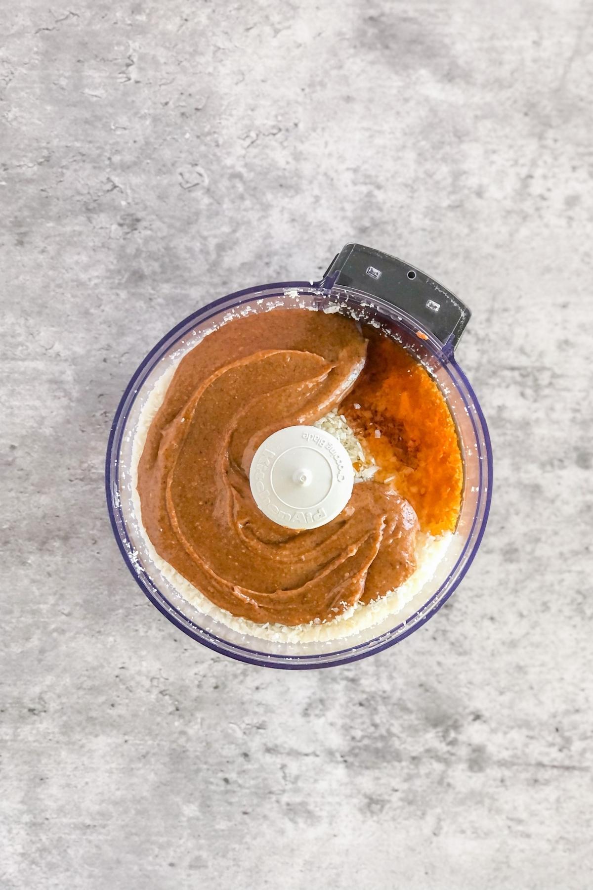 almond butter, shredded coconut, and maple syrup in a food processor