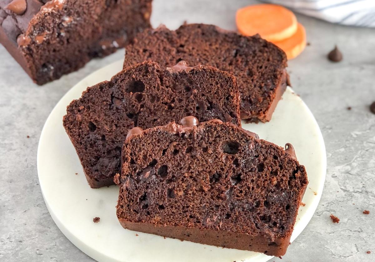 double chocolate sweet potato bread slices on a marble platter