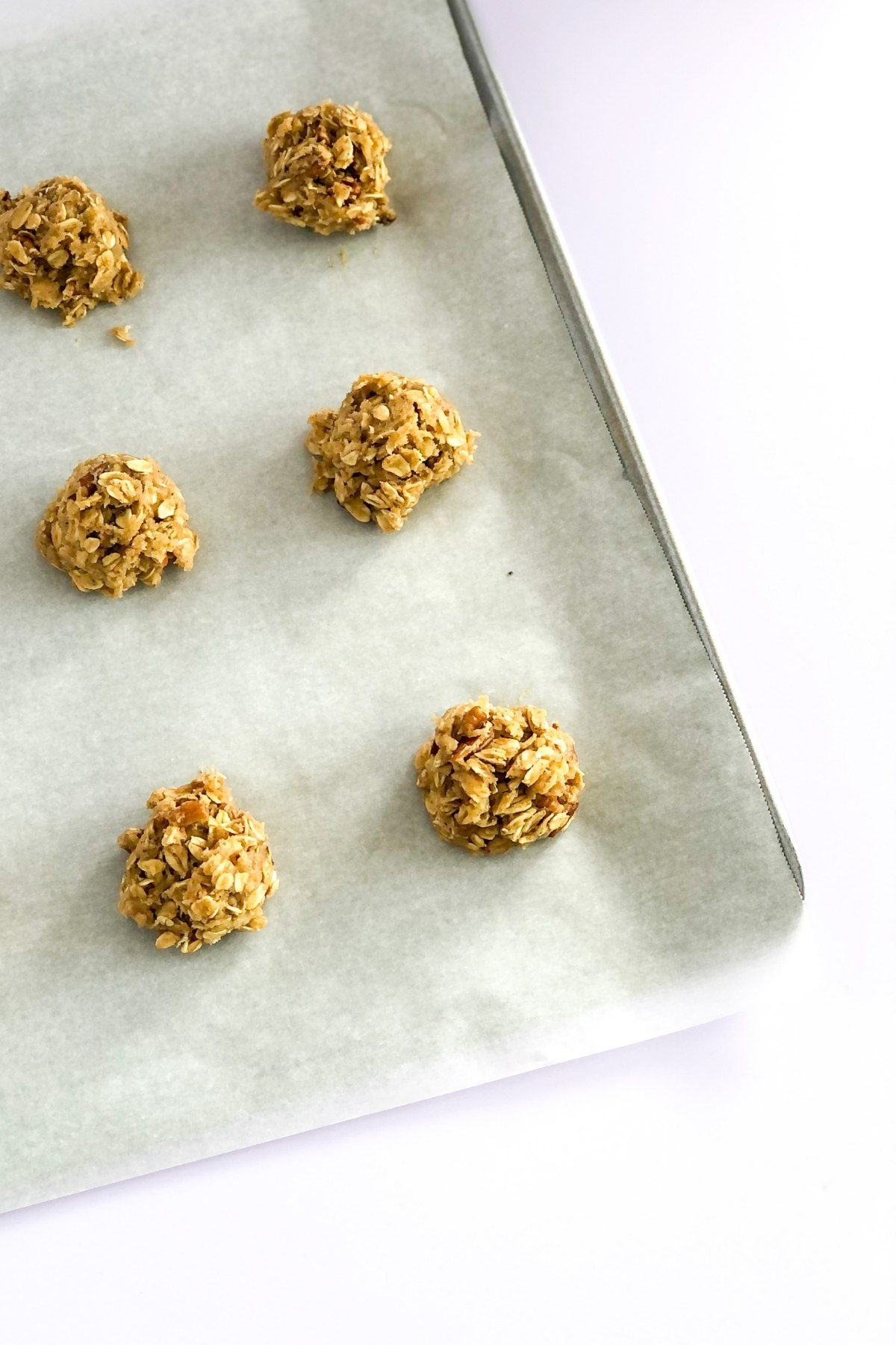oatmeal chai cookie dough balls on a baking sheet